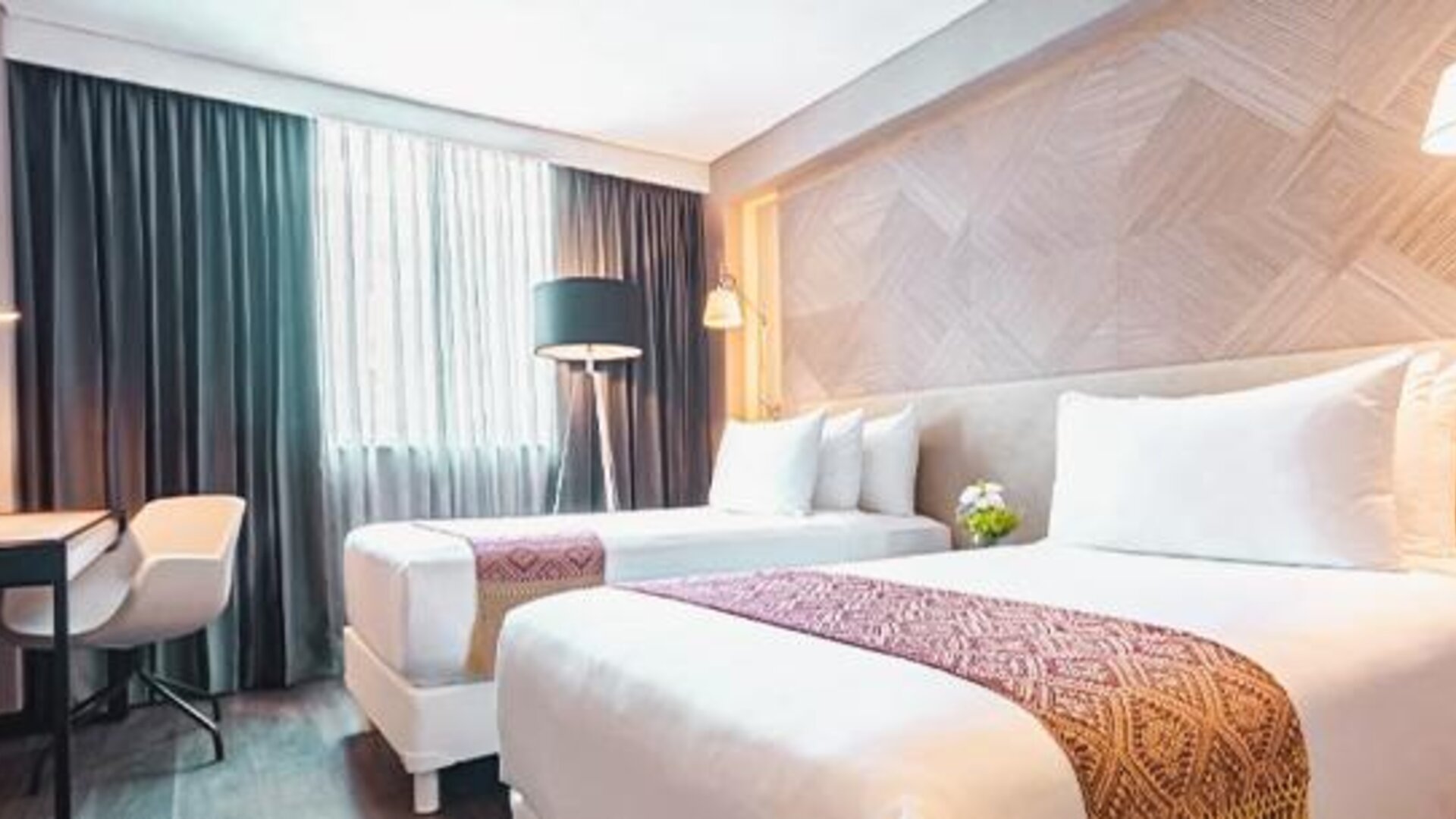 Twin guest room at NH Collection Mexico City Centro Histórico featuring two beds, a work desk, large window and modern wood décor.