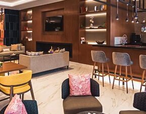 Lounge and bar area at NH Collection Mexico City Centro Histórico featuring bar seating, comfortable lounge furniture and contemporary décor.