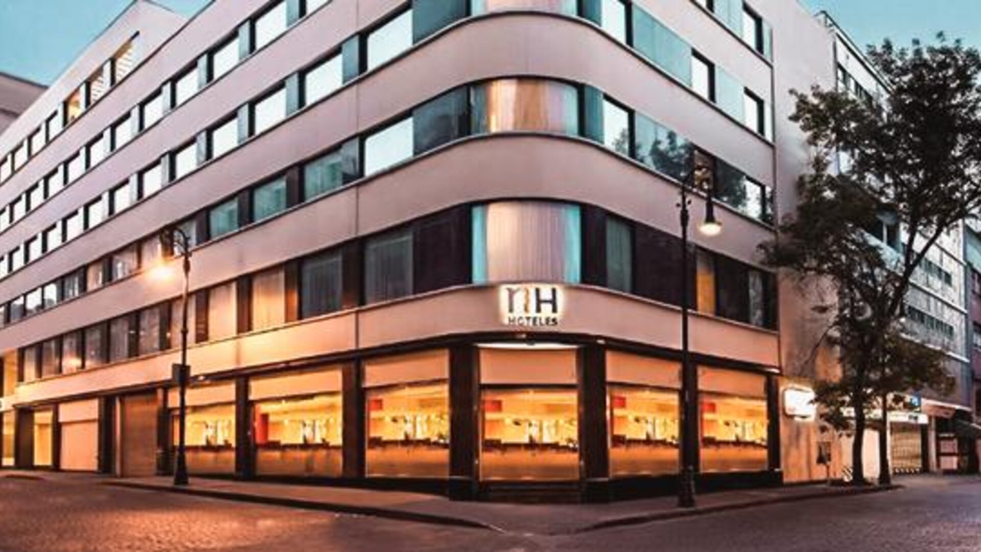 Exterior view of NH Collection Mexico City Centro Histórico featuring the contemporary hotel façade and street-level windows.