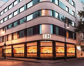 Exterior view of NH Collection Mexico City Centro Histórico featuring the contemporary hotel façade and street-level windows.