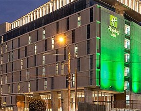 Exterior view of Holiday Inn Lima Airport featuring the multi-story hotel building illuminated at night.