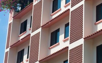 Exterior view of Hotel Benidorm featuring the multi-story hotel building and ground-floor storefronts.