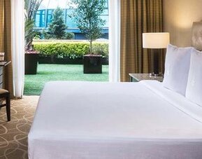 Guest room at Hotel Marquis Reforma featuring a large bed, work desk and access to a private outdoor terrace.