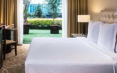 Guest room at Hotel Marquis Reforma featuring a large bed, work desk and access to a private outdoor terrace.