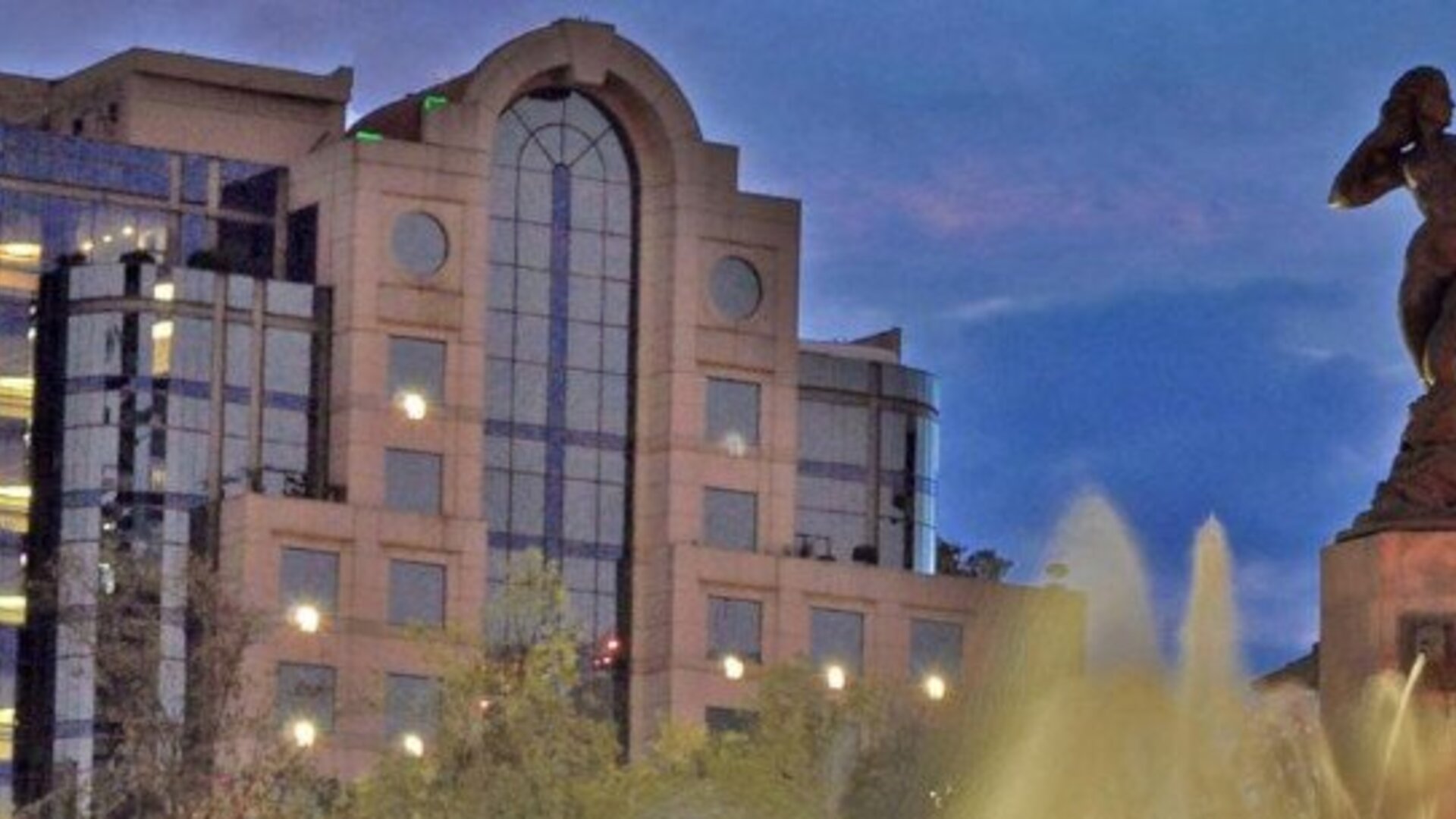 Exterior view of Hotel Marquis Reforma with the hotel building and Diana the Huntress fountain in the foreground.