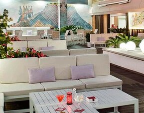 Stylish outdoor terrace featuring lounge seating, greenery and decorative lighting at NH Collection Barcelona Pódium.