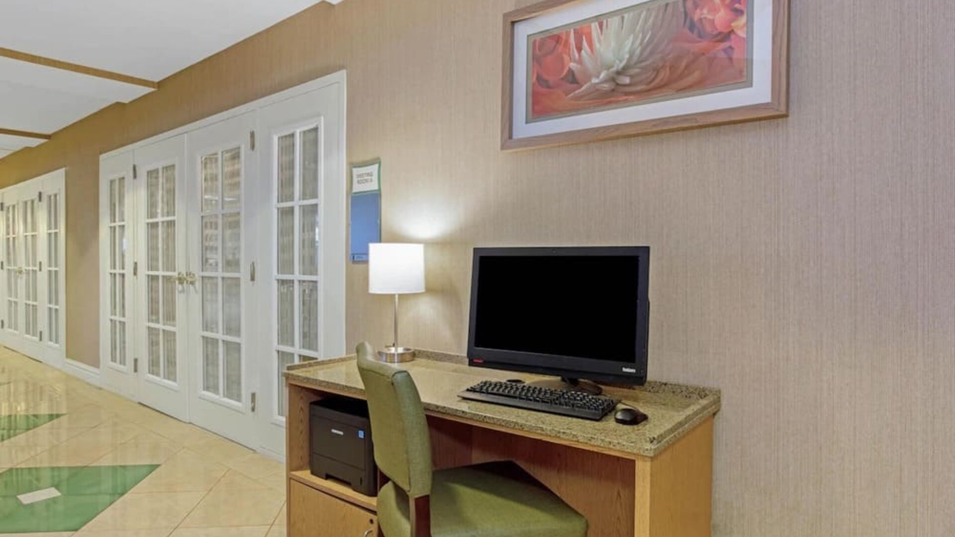Business center featuring computer access, printing facilities and a convenient workspace for guests at La Quinta Inn & Suites By Wyndham Orlando I Drive/Conv Ctr.