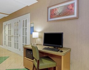 Business center featuring computer access, printing facilities and a convenient workspace for guests at La Quinta Inn & Suites By Wyndham Orlando I Drive/Conv Ctr.