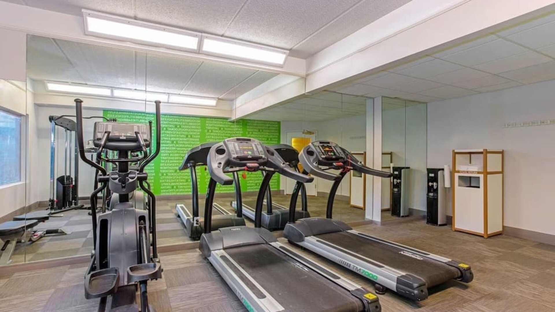 Fitness center featuring treadmills, an elliptical machine and cardio equipment for convenient workouts at La Quinta Inn & Suites By Wyndham Orlando I Drive/Conv Ctr.