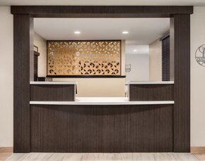 Reception desk featuring contemporary design, warm wood finishes and convenient guest services at Candlewood Suites Meridian.