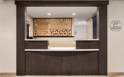 Reception desk featuring contemporary design, warm wood finishes and convenient guest services at Candlewood Suites Meridian.