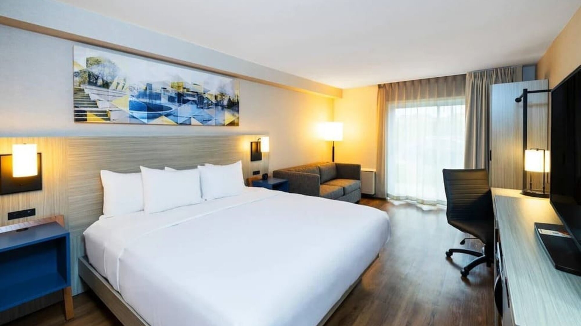 Contemporary guest room featuring a king-size bed, wood-style flooring and a spacious layout designed for comfort at Comfort Inn Truro.