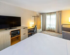 Guest room featuring an in-room workspace, a microwave, a flat-screen television and comfortable seating at Comfort Inn Truro.