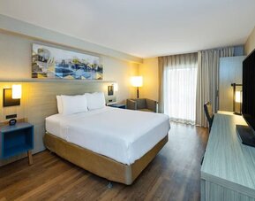Guest room featuring a king-size bed, a workspace and a comfortable layout with modern furnishings at Comfort Inn Truro.