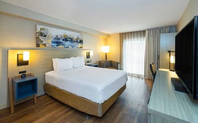 Guest room featuring a king-size bed, a workspace and a comfortable layout with modern furnishings at Comfort Inn Truro.