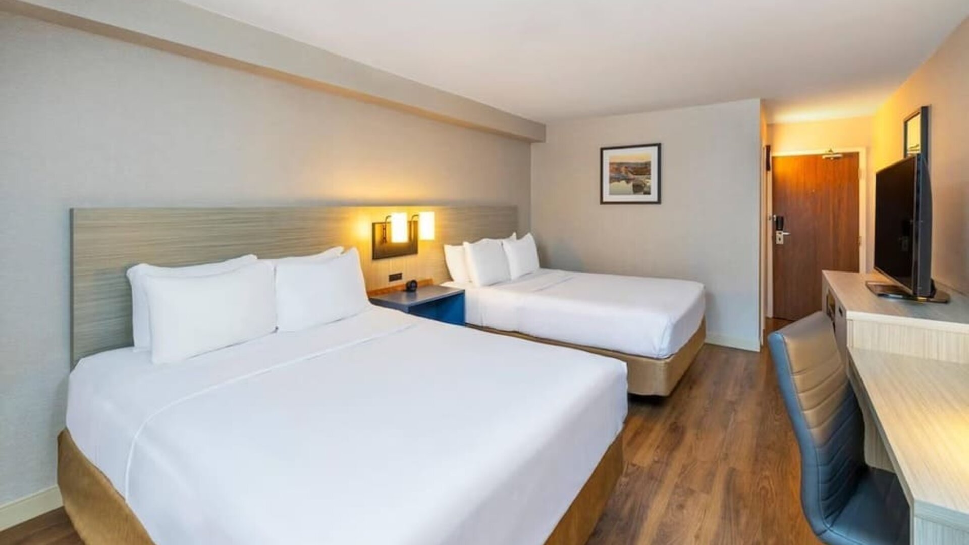 Double guest room featuring two beds, a dedicated workspace and modern accommodations at Comfort Inn Truro.
