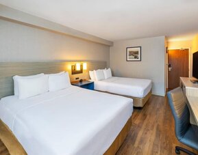 Double guest room featuring two beds, a dedicated workspace and modern accommodations at Comfort Inn Truro.