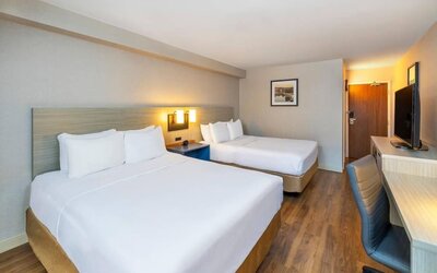 Double guest room featuring two beds, a dedicated workspace and modern accommodations at Comfort Inn Truro.