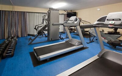 Fitness center featuring treadmills, strength-training equipment and free weights for a complete workout experience at Holiday Inn Toronto Airport East.