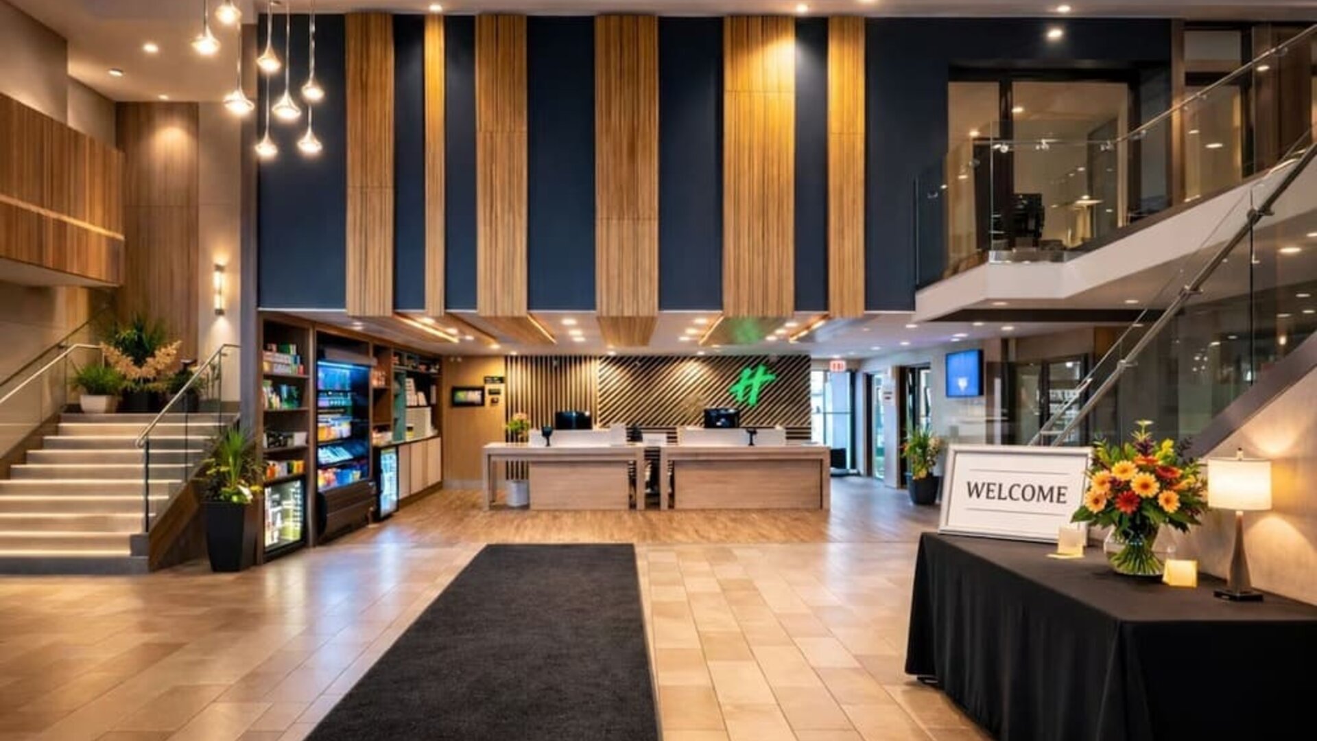 Modern hotel lobby featuring a spacious reception area, contemporary décor and comfortable gathering spaces at Holiday Inn Toronto Airport East.