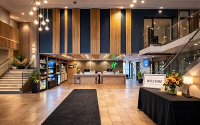 Modern hotel lobby featuring a spacious reception area, contemporary décor and comfortable gathering spaces at Holiday Inn Toronto Airport East.