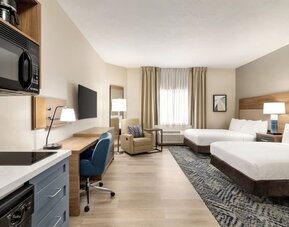 Studio-style guest room featuring two beds, a kitchenette, a dedicated workspace and modern amenities at Candlewood Suites Boise.
