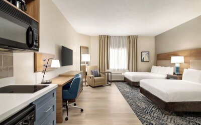 Studio-style guest room featuring two beds, a kitchenette, a dedicated workspace and modern amenities at Candlewood Suites Boise.