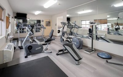 Fitness center featuring cardio equipment, strength-training machines and mirrored walls for convenient workouts at Candlewood Suites Boise.