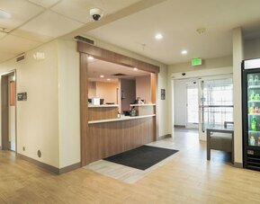 Reception area featuring a welcoming front desk, refreshment station and convenient access to hotel amenities at Candlewood Suites Boise.