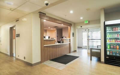 Reception area featuring a welcoming front desk, refreshment station and convenient access to hotel amenities at Candlewood Suites Boise.