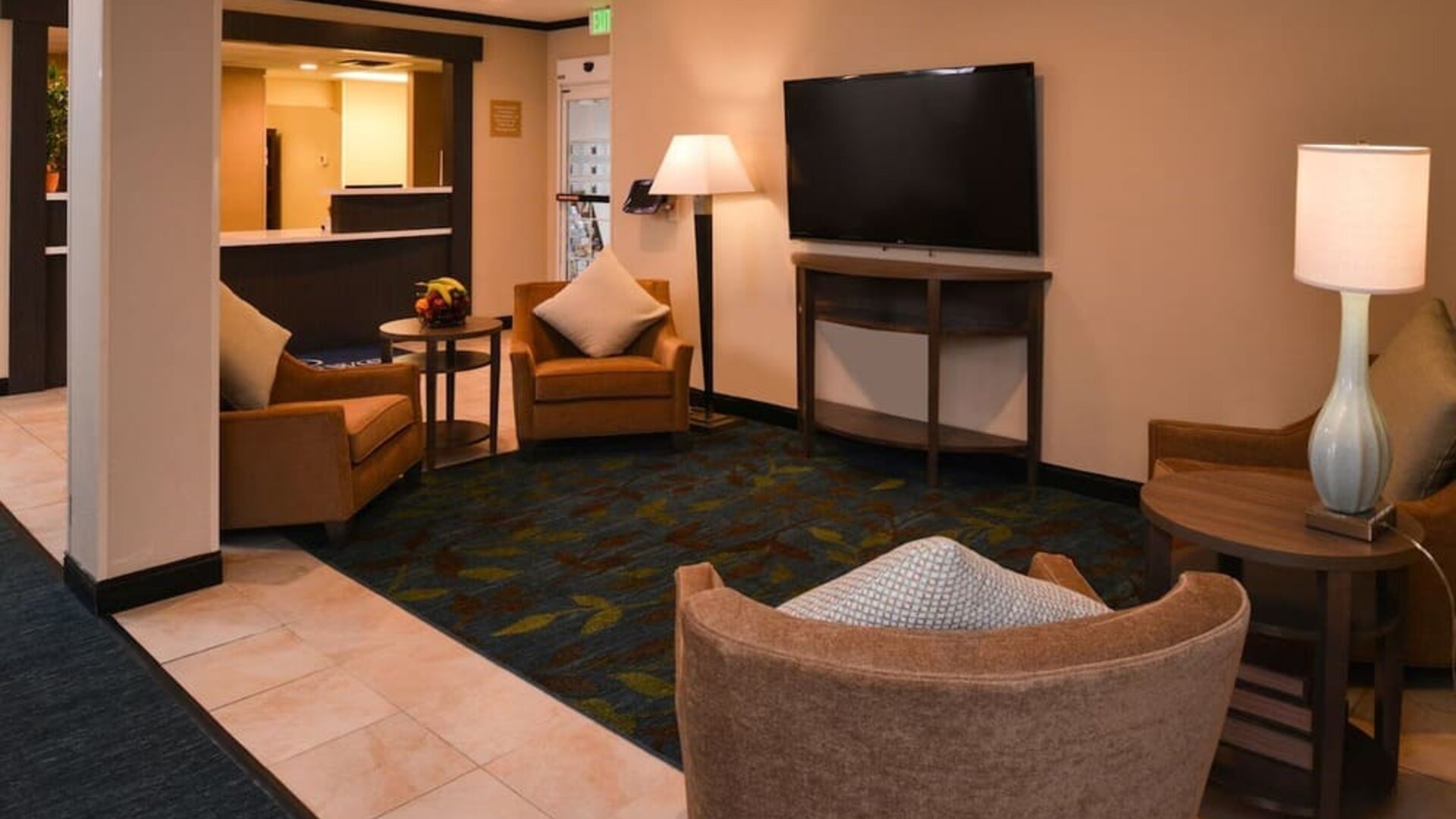 Lobby lounge featuring comfortable seating, warm wood accents and a relaxed gathering space at Candlewood Suites Boise.