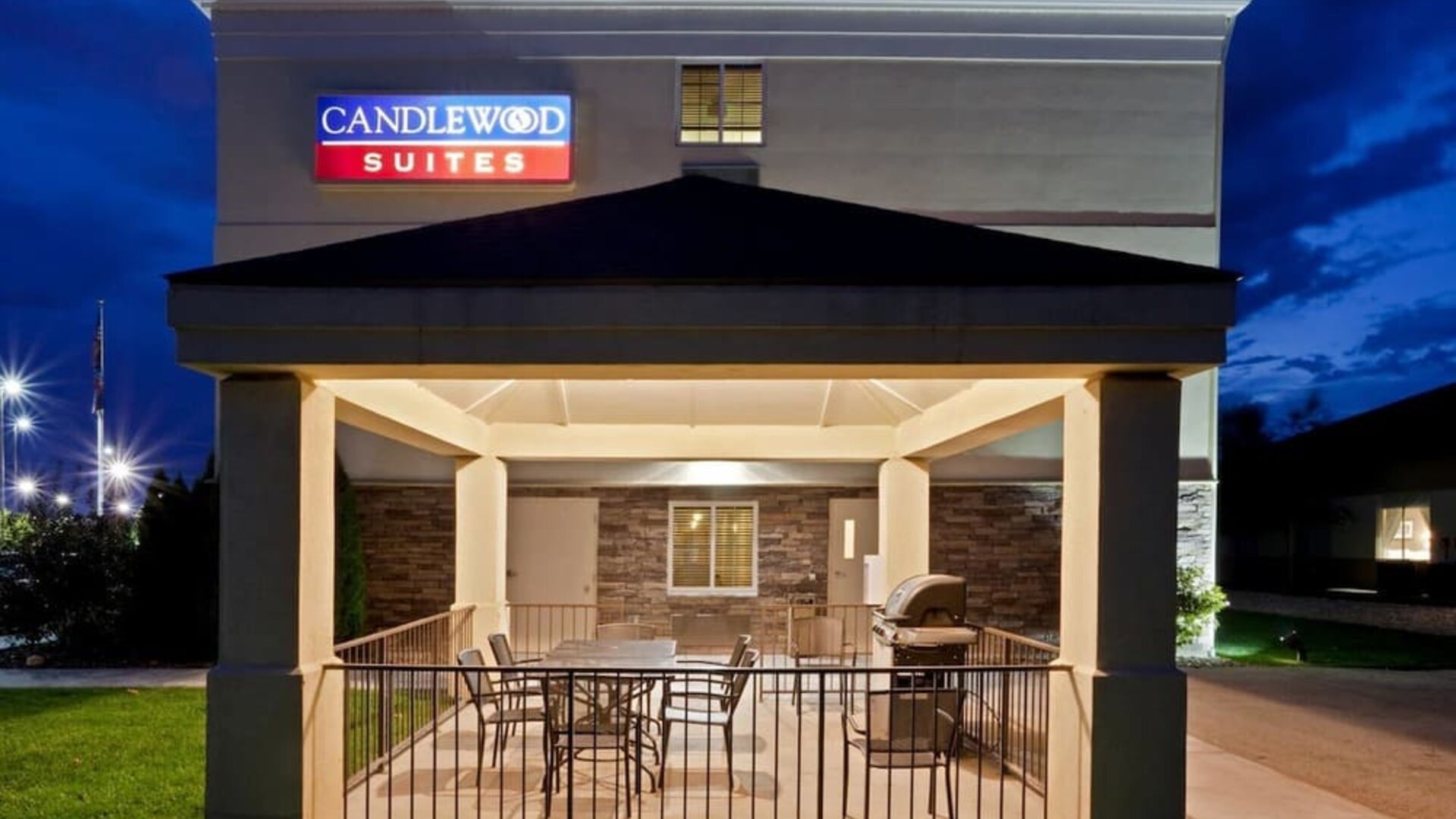 Outdoor terrace featuring covered seating and barbecue facilities for relaxing and outdoor dining at Candlewood Suites Boise.