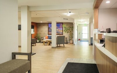 Reception lobby featuring open walkways, comfortable seating and a modern guest services area at Candlewood Suites Boise.