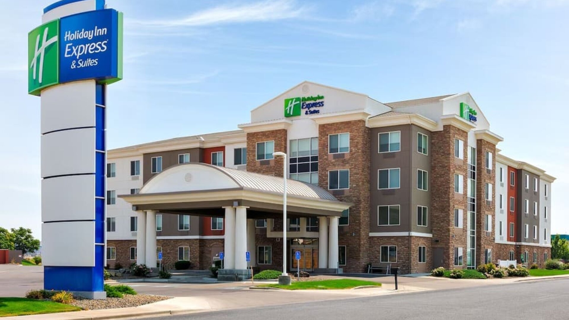 Hotel exterior featuring contemporary architecture, a covered entrance and convenient on-site parking at Holiday Inn Express & Suites Ontario.