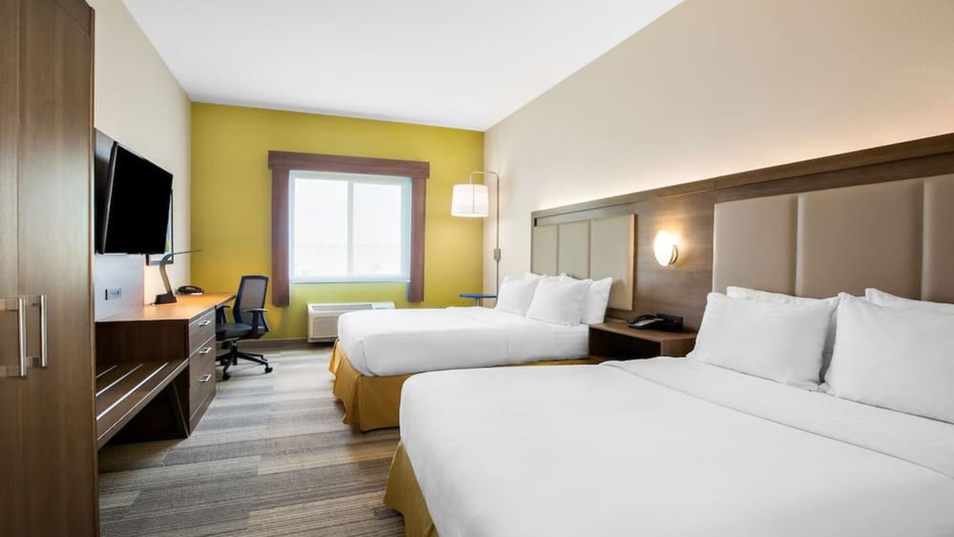 Guest room featuring two beds, a spacious layout, a work desk and contemporary furnishings designed for comfort at Holiday Inn Express & Suites Ontario.