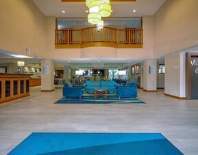 Hotel lobby featuring an open-concept layout, comfortable lounge seating and a bright, welcoming atmosphere at Holiday Inn Express SFO Airport North.