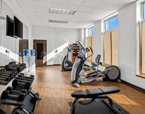 Fitness centre with cardio equipment, free weights, a weight bench, and floor-to-ceiling mirrors at Comfort Suites Frisco.