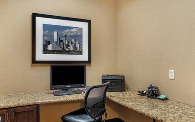 Business centre with a desktop computer, printer, and spacious granite workstations at Comfort Suites Frisco.