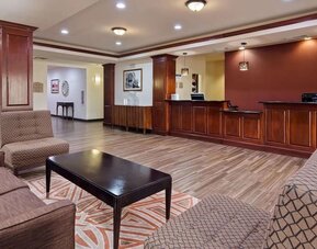 Welcoming reception and lobby area featuring comfortable seating, wood-panelled front desk, and contemporary flooring at Best Western Granbury Inn & Suites.