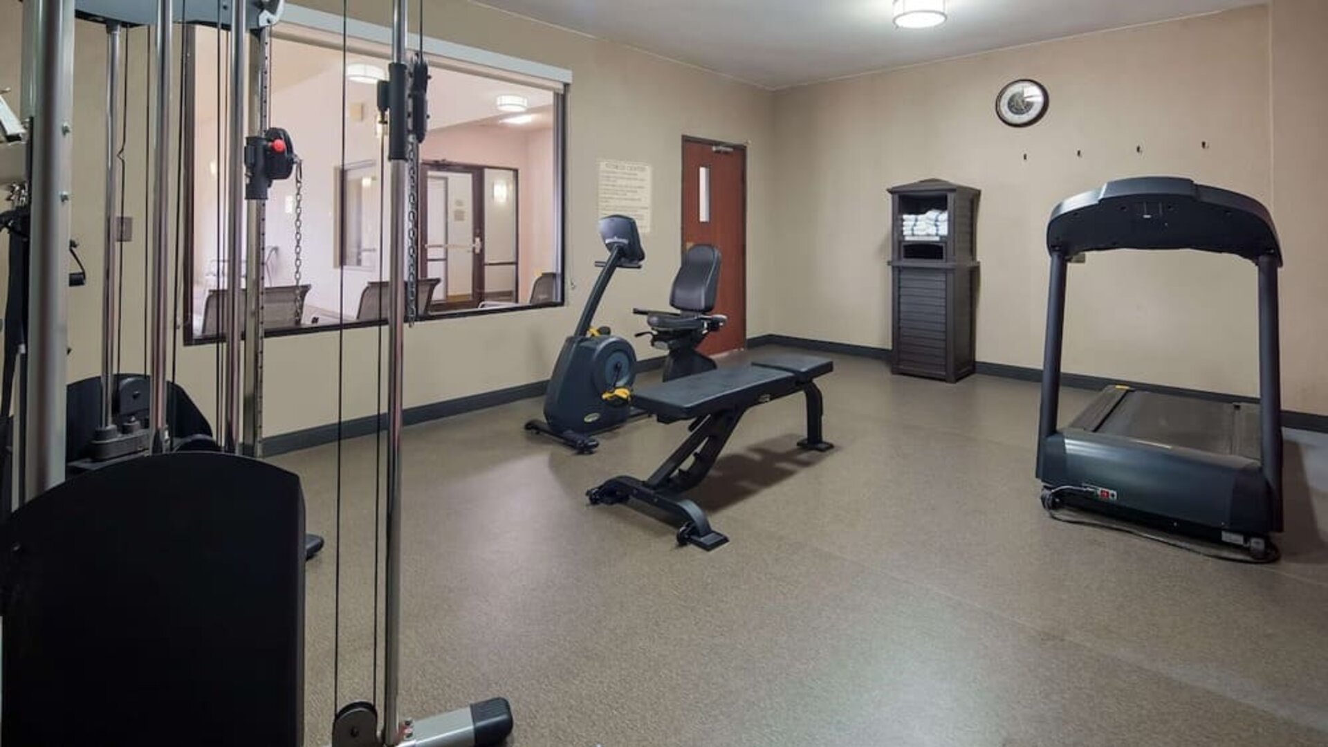 Fitness centre equipped with a treadmill, exercise bike, weight bench, and strength-training equipment at Best Western Granbury Inn & Suites.