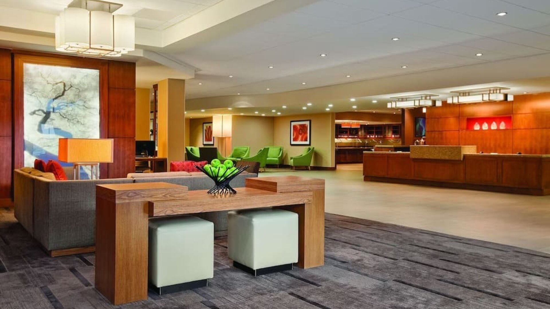 Spacious reception and lobby area featuring contemporary seating, colourful furnishings, artwork, and a front desk at Hyatt Place San Jose Downtown.
