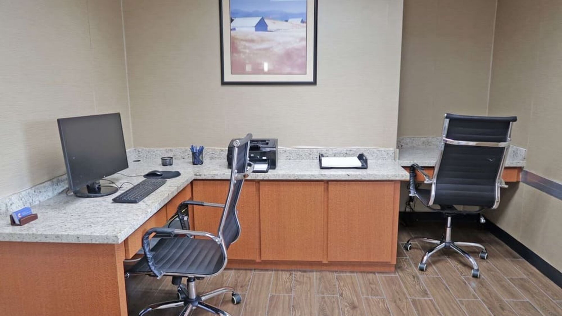 Business centre featuring computer workstations, office chairs, a printer, and countertop workspace at Comfort Inn Southwest At Westpark.
