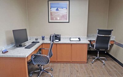 Business centre featuring computer workstations, office chairs, a printer, and countertop workspace at Comfort Inn Southwest At Westpark.