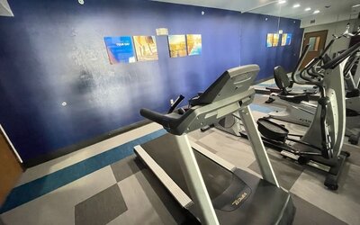 Fitness centre with treadmill, elliptical machines, exercise bike, and mirrored wall at Comfort Suites San Antonio SeaWorld - Lackland AFB.