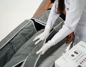 Spa wellness treatment at SKYLARANNA Resort & Spa, featuring compression therapy equipment administered by a spa professional.
