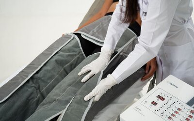 Spa wellness treatment at SKYLARANNA Resort & Spa, featuring compression therapy equipment administered by a spa professional.