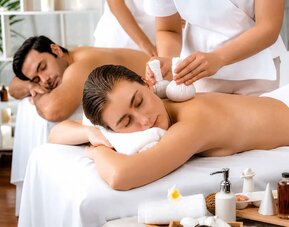 Spa treatment featuring two guests receiving massages in a relaxing treatment setting at SKYLARANNA Resort & Spa.