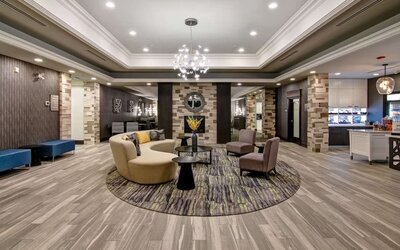 Hotel lobby with lounge area at Homewood Suites By Hilton Burlington.