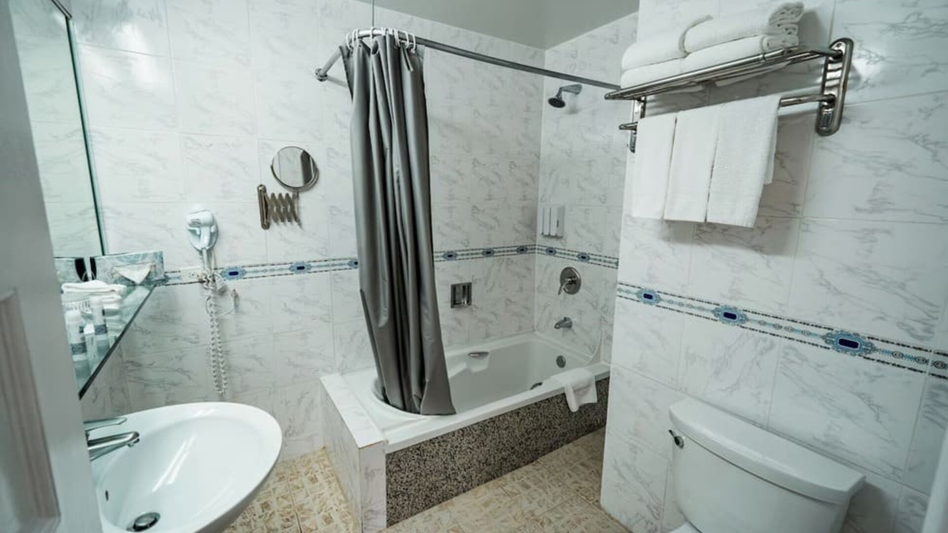 Guest bathroom with shower and tub at Congress Plaza Hotel.