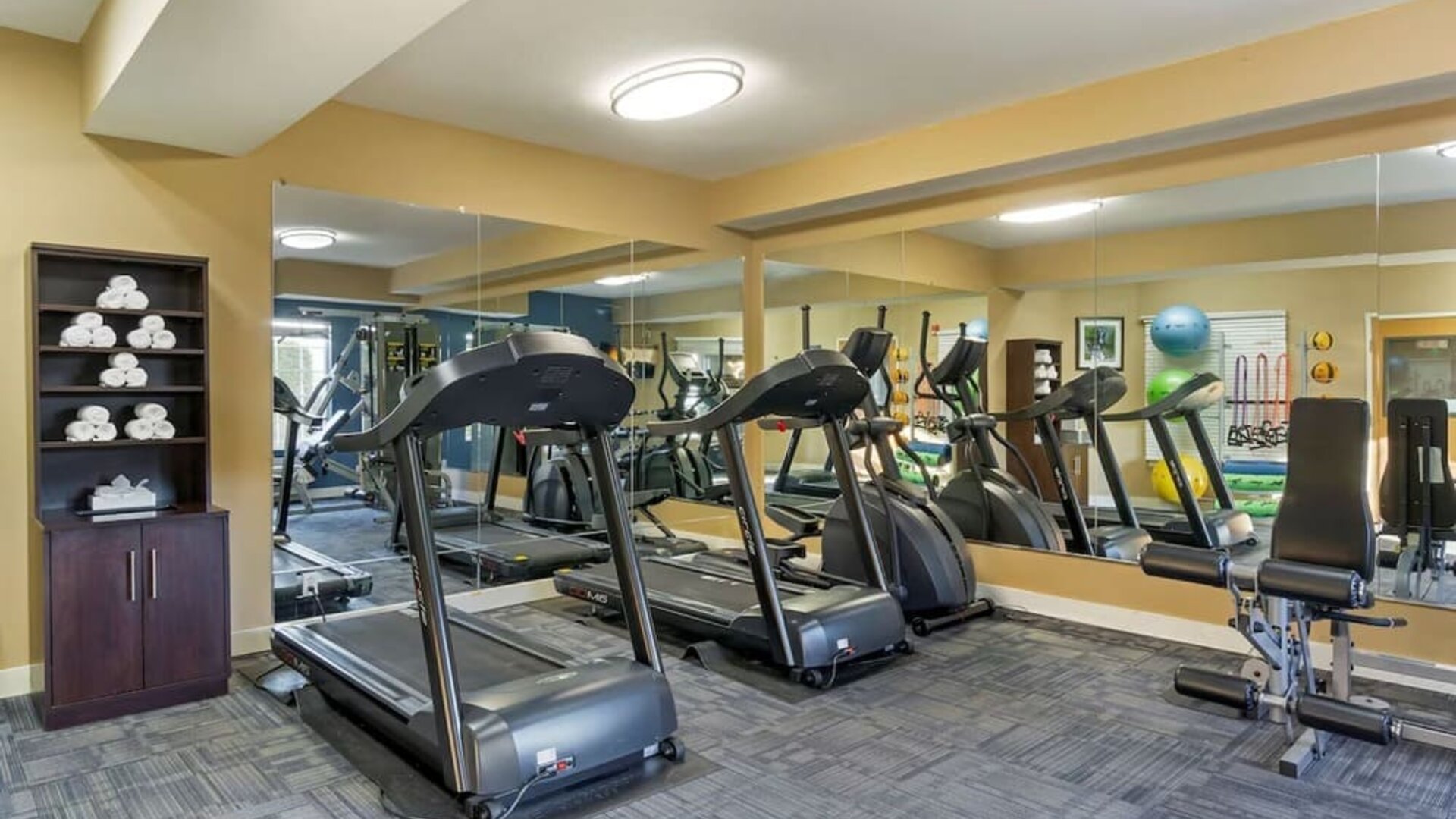 Fitness center with treadmills, elliptical machines, weights, and exercise equipment at Best Western Plus Mountain View Auburn Inn.